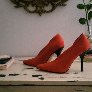Orange high heel booties.